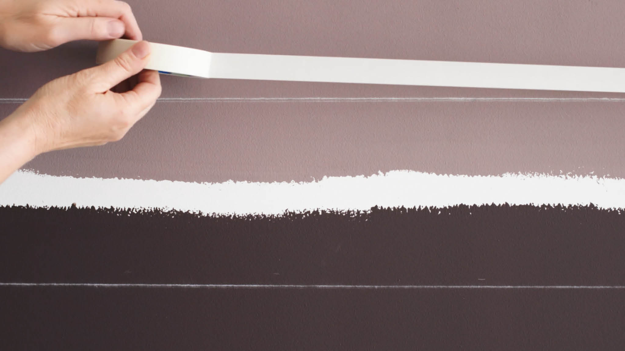 Masking tape marks the boundaries of the blurred line Apply masking tape along your chalked lines