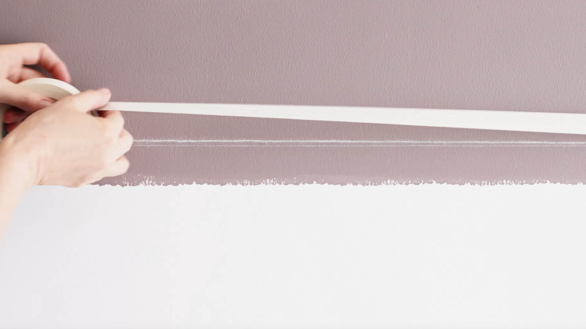 Masking tape marks the split between paint colours Apply masking tape along your chalked line when your paint is dry